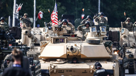 American soldiers drive Abrams M1 tanks during a military parade on Polish Armed Forces Day in Warsaw.