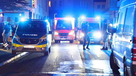 Police and ambulances stand near the scene of a stabbing attack in the German city of Solingen.