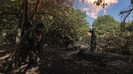 Ukrainian soldiers fire a mortar in the Donetsk People's Republic, August 18, 2024