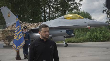 FILE PHOTO: Ukraine's Vladimir Zelensky standing against the background of Western-donated F-16 fighter jets in an undisclosed location in Ukraine, August 4, 2024