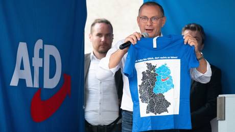 FILE PHOTO: AfD party's co-leader, Tino Chrupalla, holds a T-shirt with the inscription 