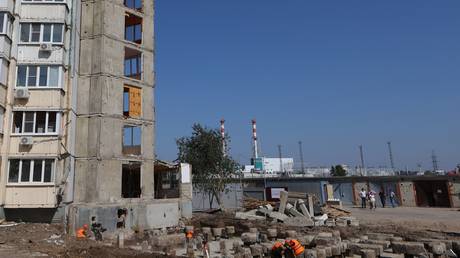 Builders restore a house in Belgorod, Russia that was damaged in an attack by Ukrainian forces.