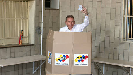 Opposition candidate Edmundo Gonzalez shows his ballot as casting his vote during the presidential elections in Caracas, Venezuela on July 28, 2024.