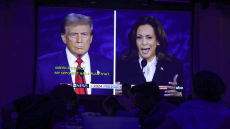 People watch the presidential debate during a debate watch party at Penn Social on September 10, 2024 in Washington, DC.