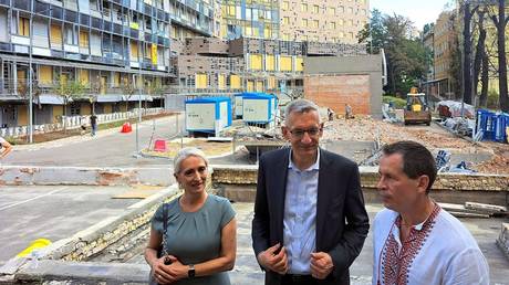 FILE PHOTO: German Ambassador Martin Jager (M) near the Okhmatdet children’s hospital in Kiev after it was hit by a missile in July.