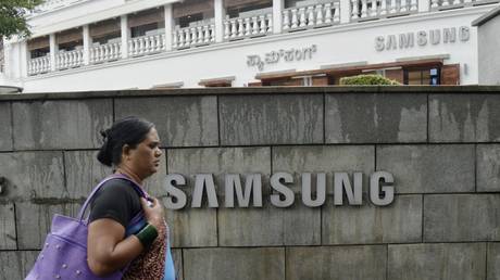 A woman walks past a Samsung logo in Bangalore, India, July 25, 2023.