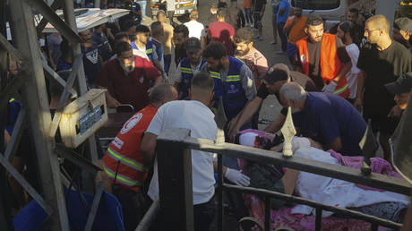 Civil Defense first-responders carry a man who was wounded after his handheld pager exploded, in the southern port city of Sidon, Lebanon, Tuesday, Sept. 17, 2024.