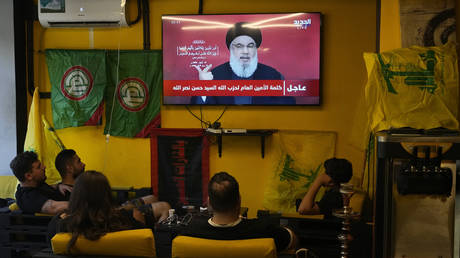 People watch the speech of Hezbollah leader Hassan Nasrallah as they sit in a cafe in the southern suburbs of Beirut, September 19, 2024.