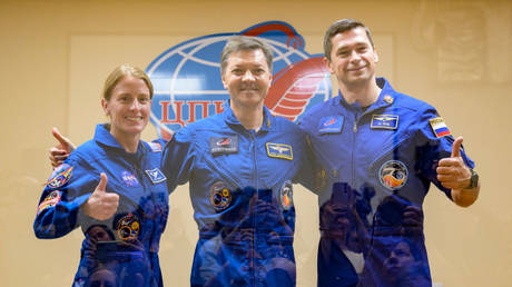 NASA astronaut Loral O'Hara and Roscosmos cosmonauts Oleg Kononenko and Nikolai Chub pose while in quarantine behind glass before launch in Baikonur, Kazakhstan. September 14, 2023