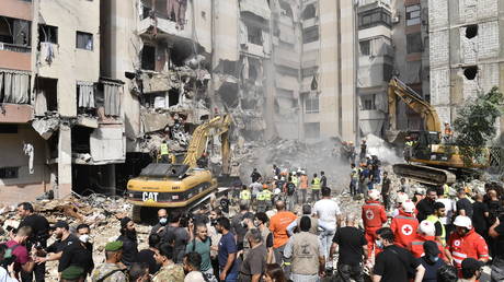 Officers use heavy construction equipment to remove debris from heavily damaged settlements following the Israeli army's air strike on the Dahieh district of southern Beirut, Lebanon on September 21, 2024.