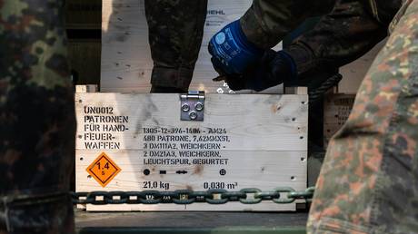 FILE PHOTO: German soldiers take munitions from a crate.