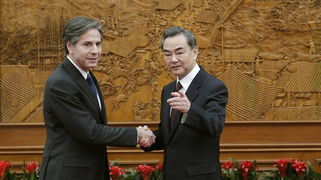 FILE PHOTO: US Secretary of State Antony Blinken shakes hand with Chinese Foreign Minister Wang Yi.