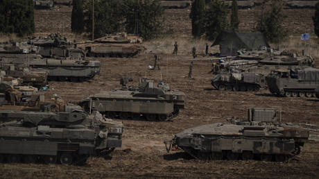 Israeli soldiers work on tanks and armoured personnel carriers (APC) in northern Israel, Monday, Sept. 30, 2024.