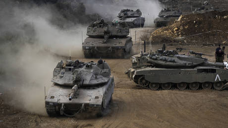 Israeli tanks maneuver in a staging area in northern Israel, near the border with Lebanon, October 1, 2024.