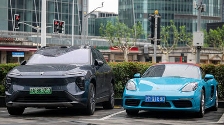 An electric car from the Chinese brand NIO and one from Porsche with a combustion engine are pictured during a visit by German Economy Minister Robert Habeck to China in June 2024.