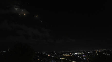 FILE PHOTO: Rockets are seen over Jerusalem as a siren sounds a warning of incoming missiles fired from Iran, in Jerusalem, October 1, 2024