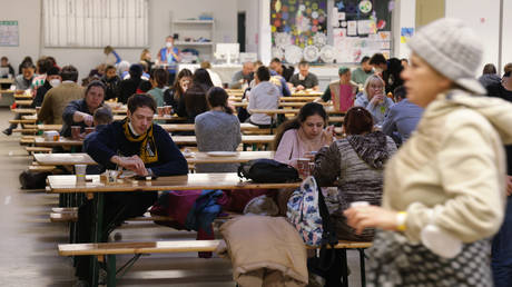  Refugees from Ukraine receive food in a cafeteria at the refugees registration center in Berlin, Germany.