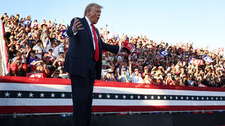 Donald Trump gestures as he walks onstage for a campaign rally in Coachella, California, October 12, 2024