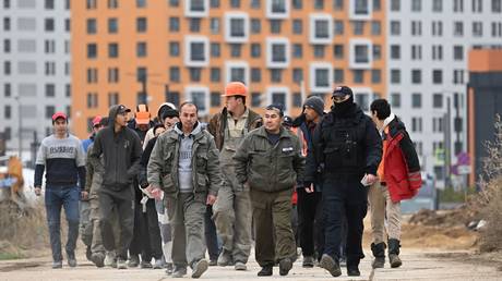 FILE PHOTO. Foreign workers during a raid on illegal migrants in Moscow.