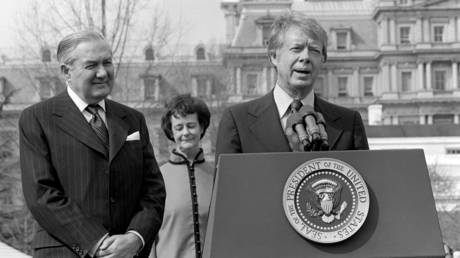 FILE PHOTO: From left, UK Prime Minister James Callaghan (1912 - 2005) & Audrey Callaghan (1915 - 2005) listen as US President Jimmy Carter speaks during an Official Arrival ceremony on the White House's South Lawn, Washington DC, March 10, 1977.