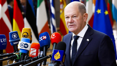 Germany's Chancellor Olaf Scholz talks to journalists as he arrives to an EU summit in Brussels, Thursday, Oct. 17, 2024.