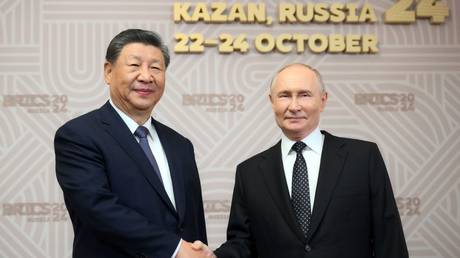 Russian President Vladimir Putin (R) meets Chinese leader Xi Jinping at the BRICS Summit in Kazan, Russia, October 22, 2024.