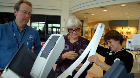  A clerk lets election judges check the zero vote count on an electronic voting machine, Broomfield, Colorado, US, October 2006