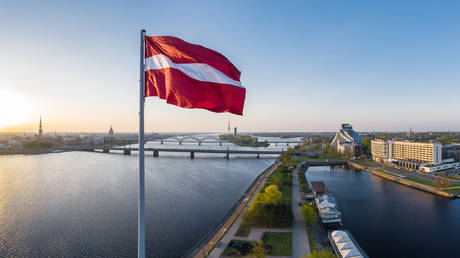 Closeup of the Latvian flag hanging above the AB dam in Riga - stock photo