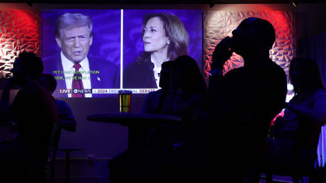 People watch the presidential debate during a debate watch party at Penn Social on September 10, 2024 in Washington, DC.