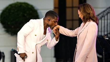 FILE PHOTO: Gospel singer Kirk Franklin kisses the hand of US Vice President Kamala Harris.