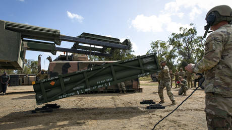 FILE PHOTO. Sgt. Jimmy Lerma readjusts an Army Tactical Missile System (ATACMS) for loading on a High Mobility Artillery Rocket System (HIMARS) at Williamson Airfield in Queensland, Australia.