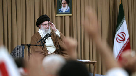 Iran's Supreme Leader Ayatollah Ali Khamenei salutes during his meeting with the Basij force in Tehran on November 25, 2024.