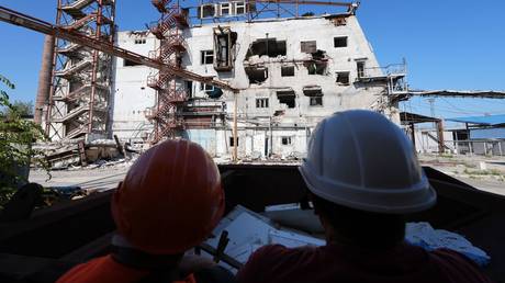 Workers repair a building at Mariupol Sea Port, Donetsk People's Republic, Russia, September 11, 2024.