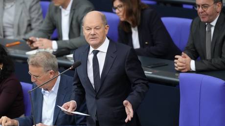 German Chancellor Olaf Scholz takes part in the questioning of the Federal Government in the plenary chamber of the Bundestag in Berlin on December 4, 2024.