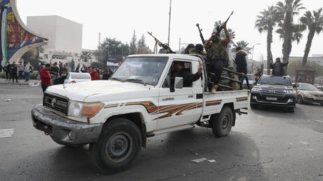 People react to the fall of Syrian regime in Umayyad Square on December 8, 2024 in Damascus, Syria.