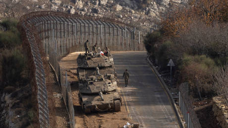 Israeli tanks operate near the Israeli border separating the occupied Golan Heights from Syria, December 9, 2024