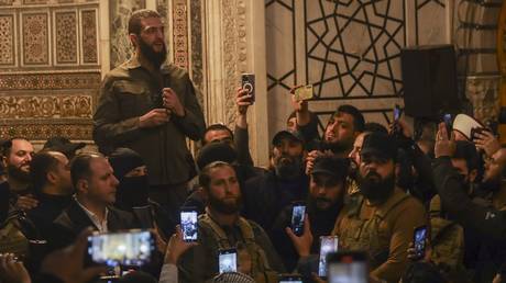 FILE PHOTO: The leader of Hayat Tahrir al-Sham (HTS), Ahmed Hussein al-Sharaa, better known by his nom de guerre Abu Mohammad al-Julani, speaks at the Umayyad Mosque in Damascus on December 8, 2024