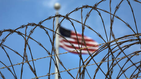 FILE PHOTO: Razor wire tops the fence of the US prison at Guantanamo Bay,