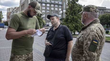 FILE PHOTO: Members of the Kharkov Regional Recruitment Office checking a civilian's documentation.