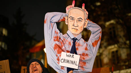 A protester holding a sign with an effigy of Israeli Prime Minister Benjamin Netanyahu in Warsaw, Poland, January 10, 2025.