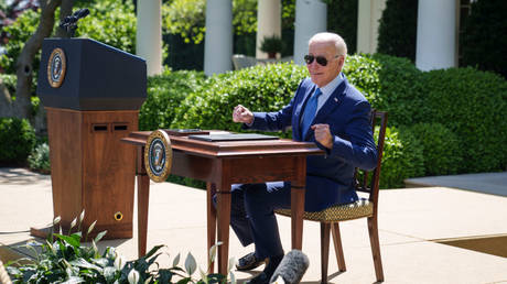 Joe Biden sits at a desk in the Rose Garden of the White House in Washington DC, April 21, 2023