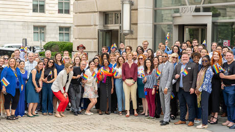 FILE PHOTO: USAID staff raise Pride flags outside headquarters in Washington, June 5, 2024