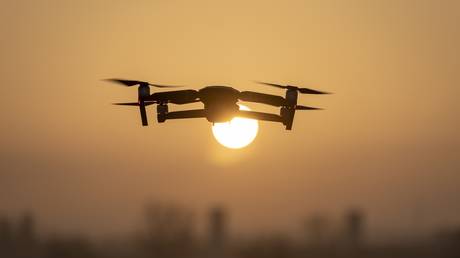 FILE PHOTO: A drone flies during a sunrise.