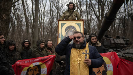 FILE PHOTO: Orthodox priest Petr Gritsenko conducts the Epiphany service for Russian servicemen at a position of a tank unit, as Russia's military operation in Ukraine continues, in Luhansk People's Republic, Russia.