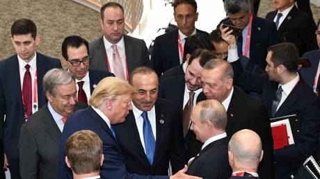 FILE PHOTO: Turkish President Recep Tayyip Erdogan, US President Donald Trump and Russian President Vladimir Putin chat on the second day of the G20 summit at INTEX Osaka Exhibition Center in Osaka, Japan on June 29, 2019.