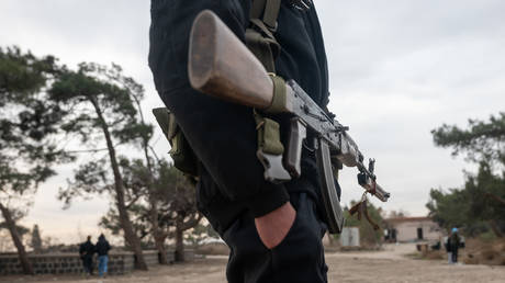 FILE PHOTO: Hayat Tahrir al-Sham (HTS) fighters patrol in the city of Homs, Syria, January 22, 2025.