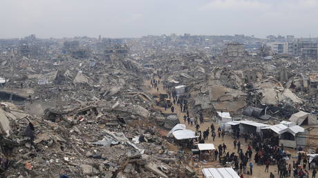 Palestinians walk through the ruins of the Jabalia refugee camp, Gaza, February 5, 2025.