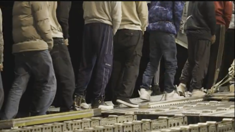 Screengrab from a video posted by United States Border Patrol showing Indian migrants in shackles being escorted to a flight for deportation from the US.