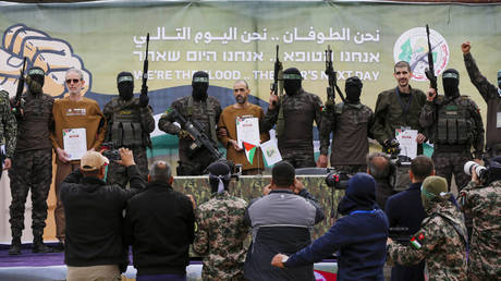 Israeli hostages being handed over by Hamas to the International Committee of the Red Cross in Deir al Balah, Gaza.