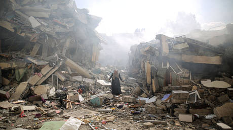 FILE PHOTO: A resident gets upset as she walks amid near the rubble of residential buildings after Israeli airstrikes at al-Zahra neighborhood in Gaza Strip on October 19, 2023.